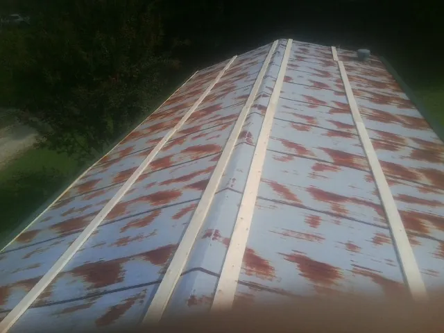 Rusted metal roof panels with new wood purlins before replacement — Storm Damage Roof Repair in Sapphire by Roofing Brothers